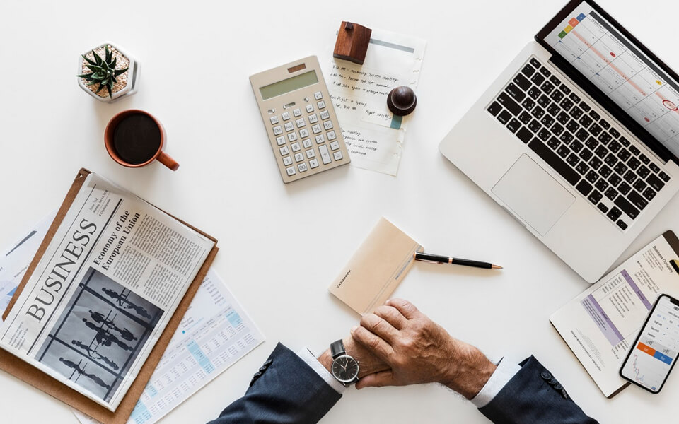 Business workspace with laptop, documents, and planning tools